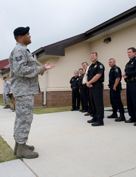 Tech. Sgt. Paul Eversley, 2nd Security Forces Squadron canine unit, briefs local law enforcement officers on military working dogs outside the 2nd Security Forces Squadron building on Barksdale Air Force Base, La., Oct. 27. Eversley explained some of the differences between military working dogs and civilian olice dogs. Fifteen members of the Bossier Sheriff and Police departments visited Barksdale to see day-to-day base operations and meet with 2 SFS Airmen.(U.S. Air Force photo/Airman 1st Class Benjamin Gonsier)(RELEASED)