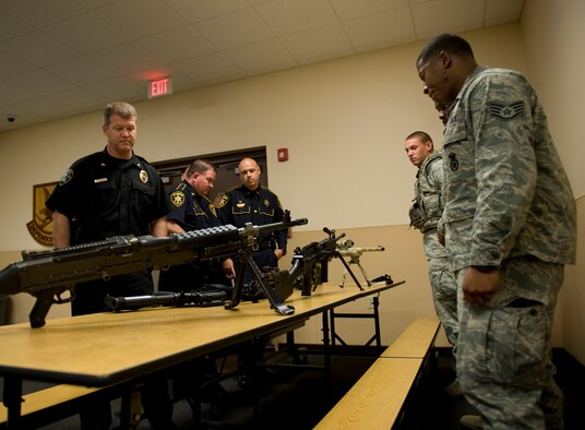 Members of the 2nd Security Forces Squadron display weapons for local law enforcement officers in the new 2 SFS building on Barksdale Air Force Base, La., Oct. 27. The community police officers were invited by the 2 SFS to tour its new facility on base and share law enforcement ideas. (U.S. Air Force photo/Airman 1st Class Benjamin Gonsier)(RELEASED)