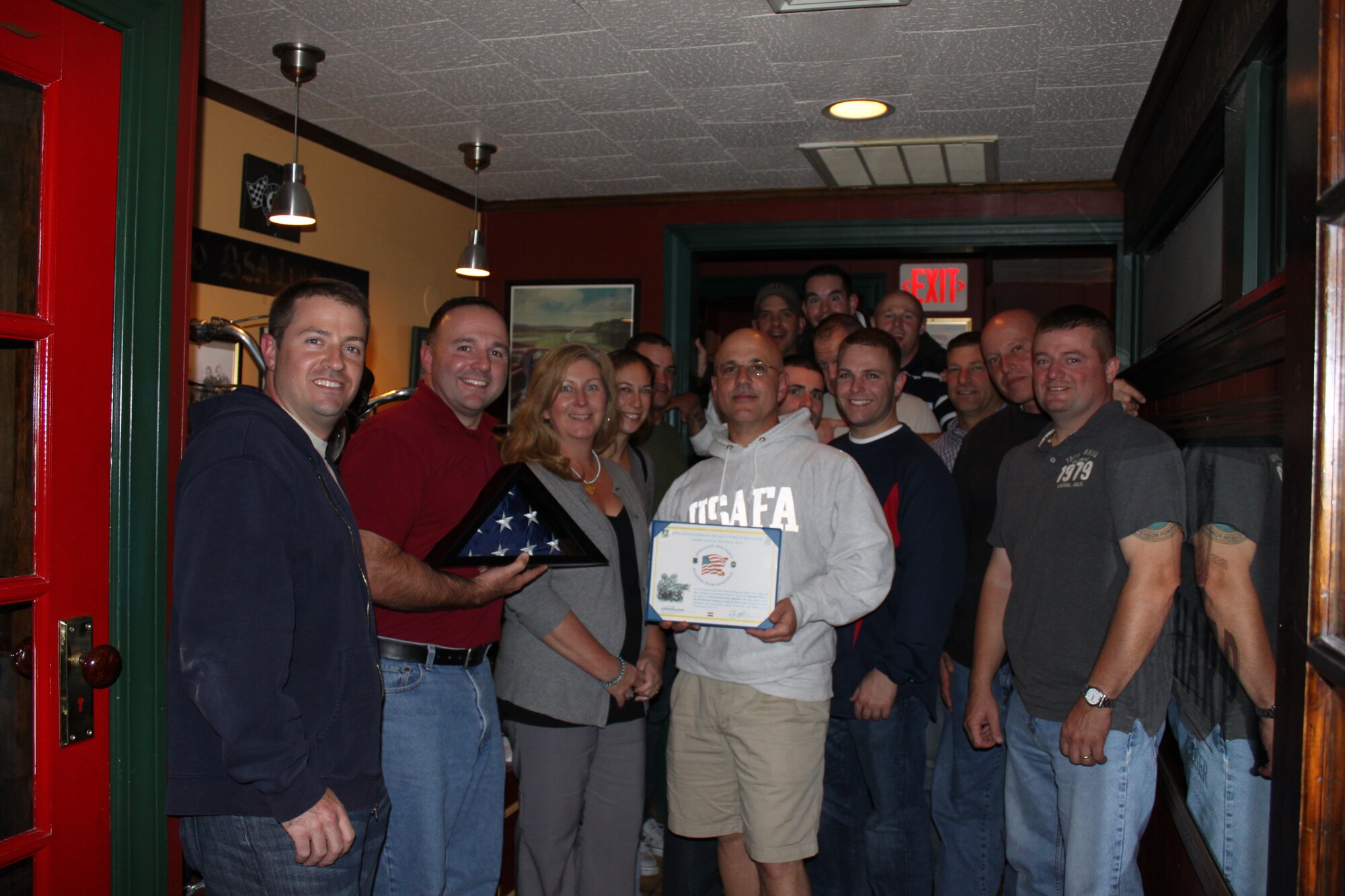 Members of the 102nd Security Forces Squadron present a Certificate of Appreciation to the British Beer Company, from Sandwich, Mass. The company raised funds and shipped Christmas stockings and other items to deployed SFS members, including those from the 102nd, over the 2010 holiday season.