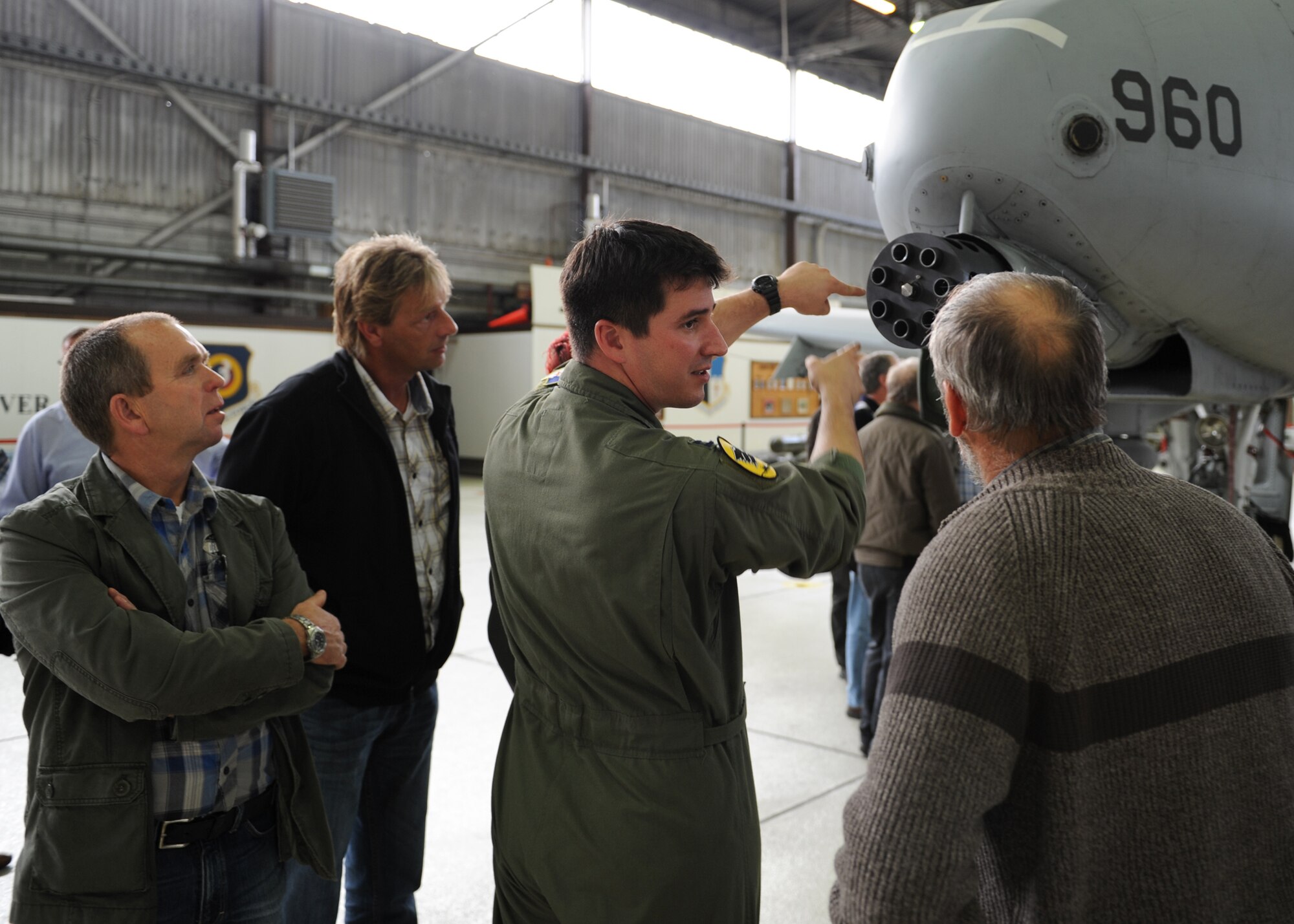SPANGDAHLEM AIR BASE, Germany – Capt. James Schmidt, 81st Fighter Squadron A-10 Thunderbolt II pilot, explains the rotation of the gun on an A-10 to members of Obere Kyll Area Administration during a tour here Oct. 28. The group is the administrative body for 14 communities within the Juenkerath area. The event included a tour of base housing, the 726th Air Mobility Squadron, an aircraft hanger, and the fire department. Members of the area administration learned more about the base, aircraft, and 52nd Fighter Wing mission helping develop partnership with the U.S. Air Force. (U.S. Air Force photo/Senior Airman Christopher Toon)