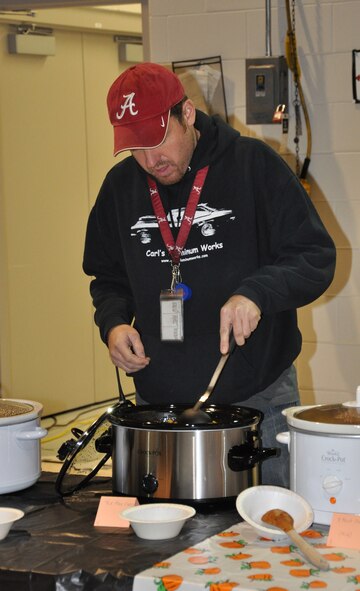 WRIGHT-PATTERSON AIR FORCE BASE, Ohio – Master Sgt. Brock Felgenhauer, 445th Aircraft Maintenance Squadron, stirs his Tex Mex chili during the 445th Airlift Wing Chili Cook-Off Oct. 27. The event raised $250 for the Combined Federal Campaign. (U.S. Air Force photo/Stacy Vaughn)