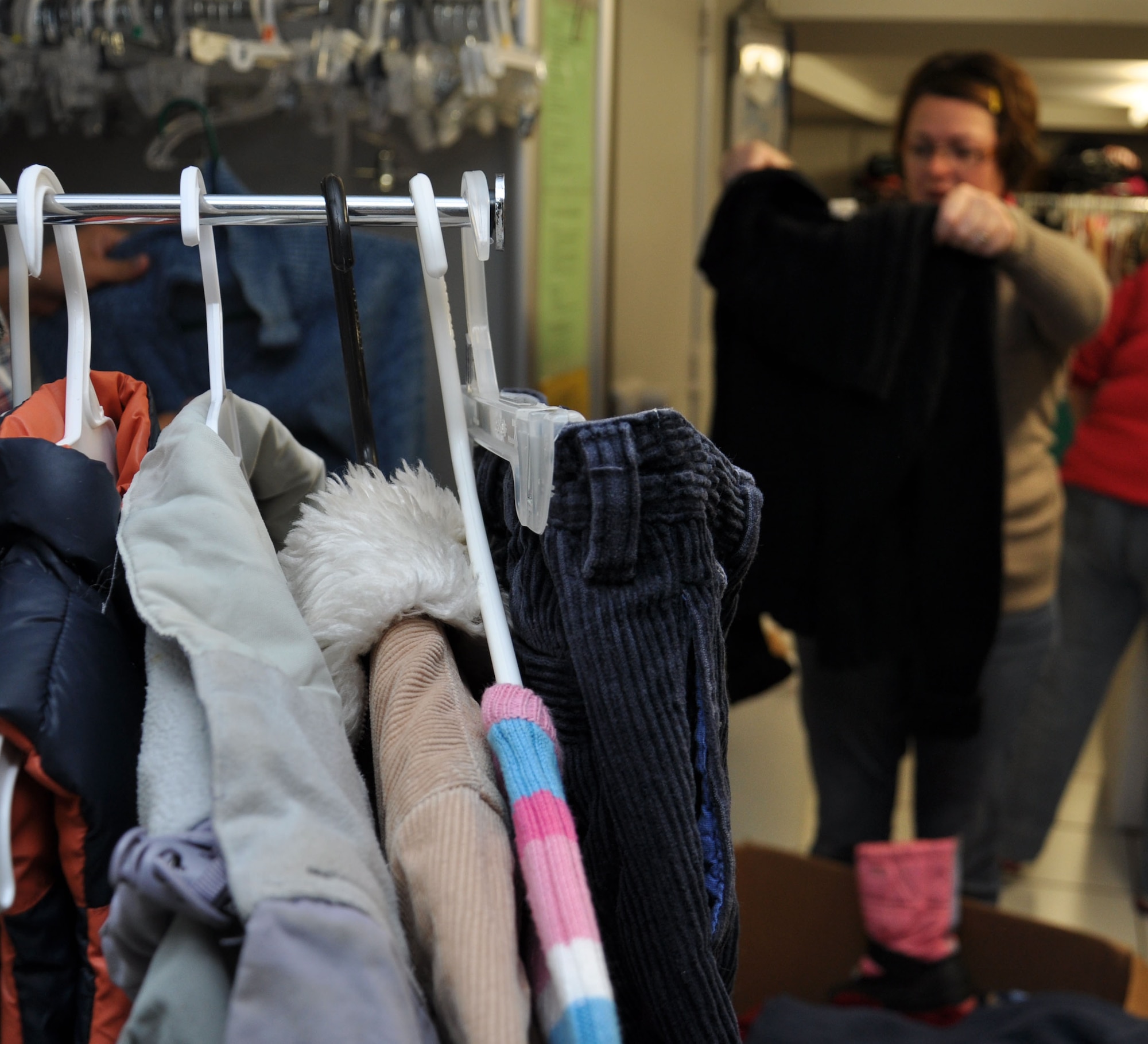 SPANGDAHLEM AIR BASE, Germany -- Manu Gilbert, Airmen’s Attic volunteer, folds donated clothing to put on the shelves at the Airmen’s Attic here Oct. 28. The Airmen’s Attic is available for all Airmen to pick up and donate household items and clothing. They are open Tuesday and Thursday from 10 a.m. – 2 p.m. and Wednesday from 1 – 6 p.m. to serve Saber Airmen and their families. (U.S. Air Force photo/Senior Airman Natasha E. Stannard)