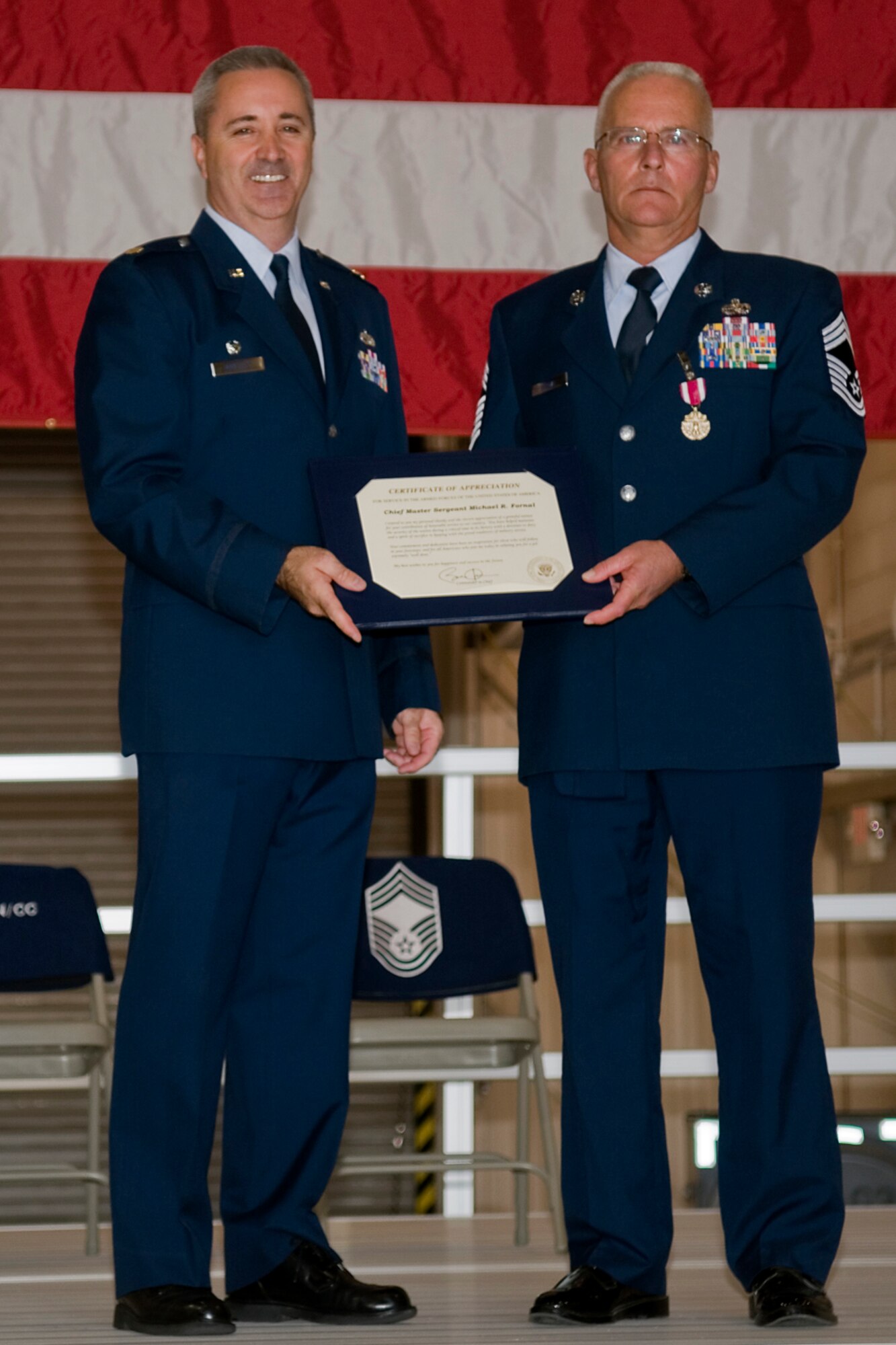 GRISSOM AIR RESERVE BASE, Ind. -- Chief Master Sgt. Michael Fornal, 434th Aircraft Maintenance Squadron superintendant, receives his certificate of appreciation from Maj. Timothy Bartlett, 434th AMXS commander, during his retirement ceremony Oct. 15. Fornal retired after serving 34 years in the in the Air Force. (U.S. Air Force photo/Senior Airman Jami K. Lancette)