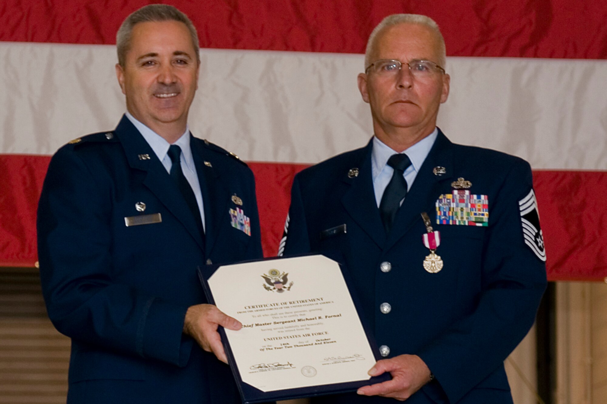 GRISSOM AIR RESERVE BASE, Ind. -- Chief Master Sgt. Michael Fornal, 434th Aircraft Maintenance Squadron superintendant, receives his certificate of retirement from Maj. Timothy Bartlett, 434th AMXS commander, during his retirement ceremony Oct. 15. Fornal retired after serving 34 years in the Air Force. (U.S. Air Force photo/Senior Airman Jami K. Lancette)