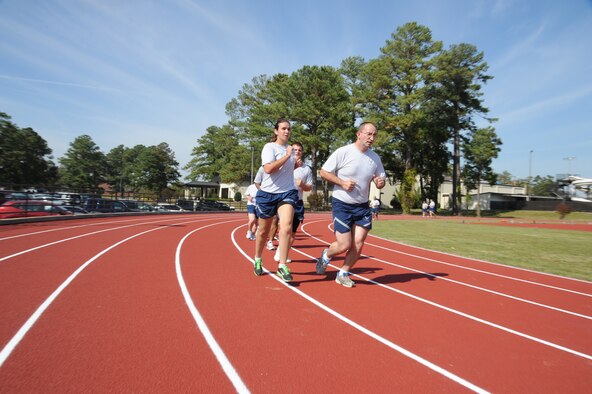 Airman 1st Class Vanessa Roberts sprints to the front of a line during an indian run while participating in a fitness improvement training (FIT) session on Seymour Johnson Air Force Base, N.C., Oct. 26, 2011. The FIT program is to aid Airmen to meet and exceed required U.S. Air Force physical fitness levels. Roberts is a 4th Aircraft Maintenance Squadron crew chief and a native of Galax, Va. (U.S. Air Force photo by Senior Airman Whitney Stanfield)   