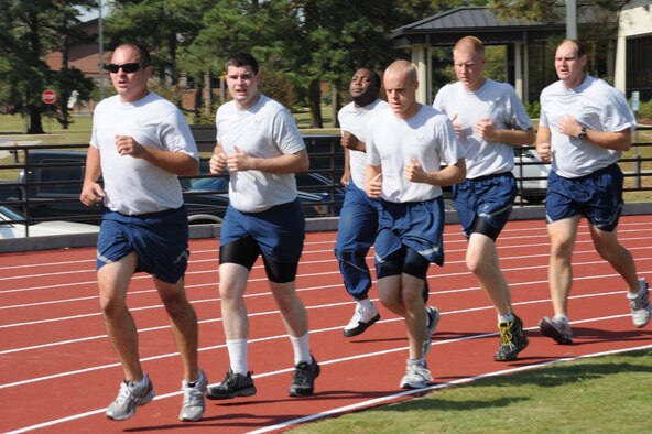 Senior Airman Antoine Coleman sprints to the front during an indian run while participating in a fitness improvement training (FIT) session on Seymour Johnson Air Force Base, N.C., Oct. 26, 2011. The FIT program is geared for every Airman to maintain a healthy lifestyle and excel in physical fitness to accomplish the wing?s mission. Coleman is a 4th Aircraft Maintenance Squadron material management technician and a native of Fayetteville, N.C. (U.S. Air Force photo by Senior Airman Whitney Stanfield)   
