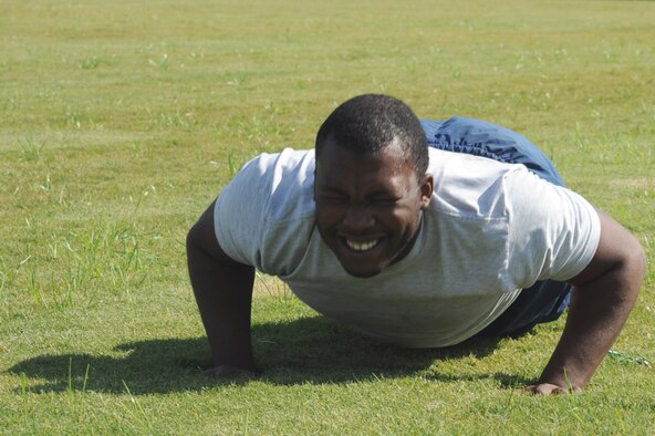 Senior Airman Antoine Coleman pushes himself to complete a push-up during a fitness improvement training session on Seymour Johnson Air Force Base, N.C., Oct. 26, 2011. During the session, Coleman had to perform proper planks, sprints, flutter kicks and bear crawls. Coleman is a 4th Aircraft Maintenance Squadron material management technician and a native of Fayetteville, N.C. (U.S. Air Force photo by Senior Airman Whitney Stanfield)   