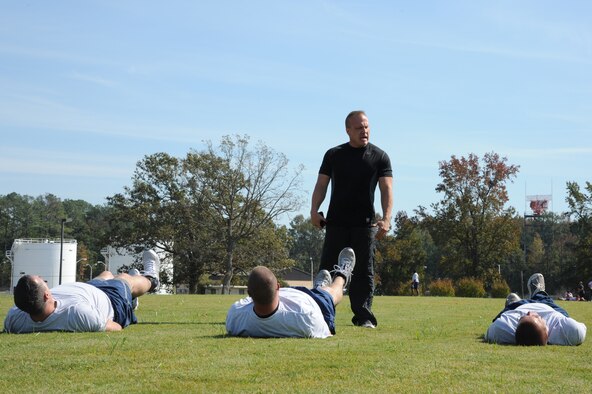 Michael Unden, 4th Force Support Squadron military fitness specialist, motivates Airmen during a fitness improvement training session on Seymour Johnson Air Force Base, N.C., Oct. 26, 2011. Unden, prior U.S. Marine Corps drill instructor, uses Marine fitness tactics to help Air Force members get in shape.  Unden is a native of Wichita, Kan. (U.S. Air Force photo by Senior Airman Whitney Stanfield)   