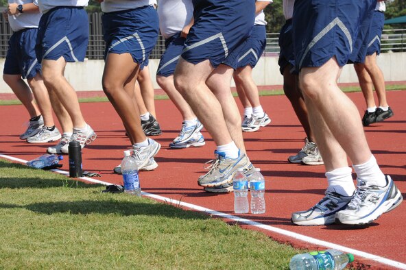 Airmen run in place during a warm-up session on Seymour Johnson Air Force Base, N.C., Oct. 26, 2011. The Airmen warm-up joints to prepare for 45 minutes of high intensity psychical training while participating in the fitness improvement training program. (U.S. Air Force photo by Senior Airman Whitney Stanfield)   