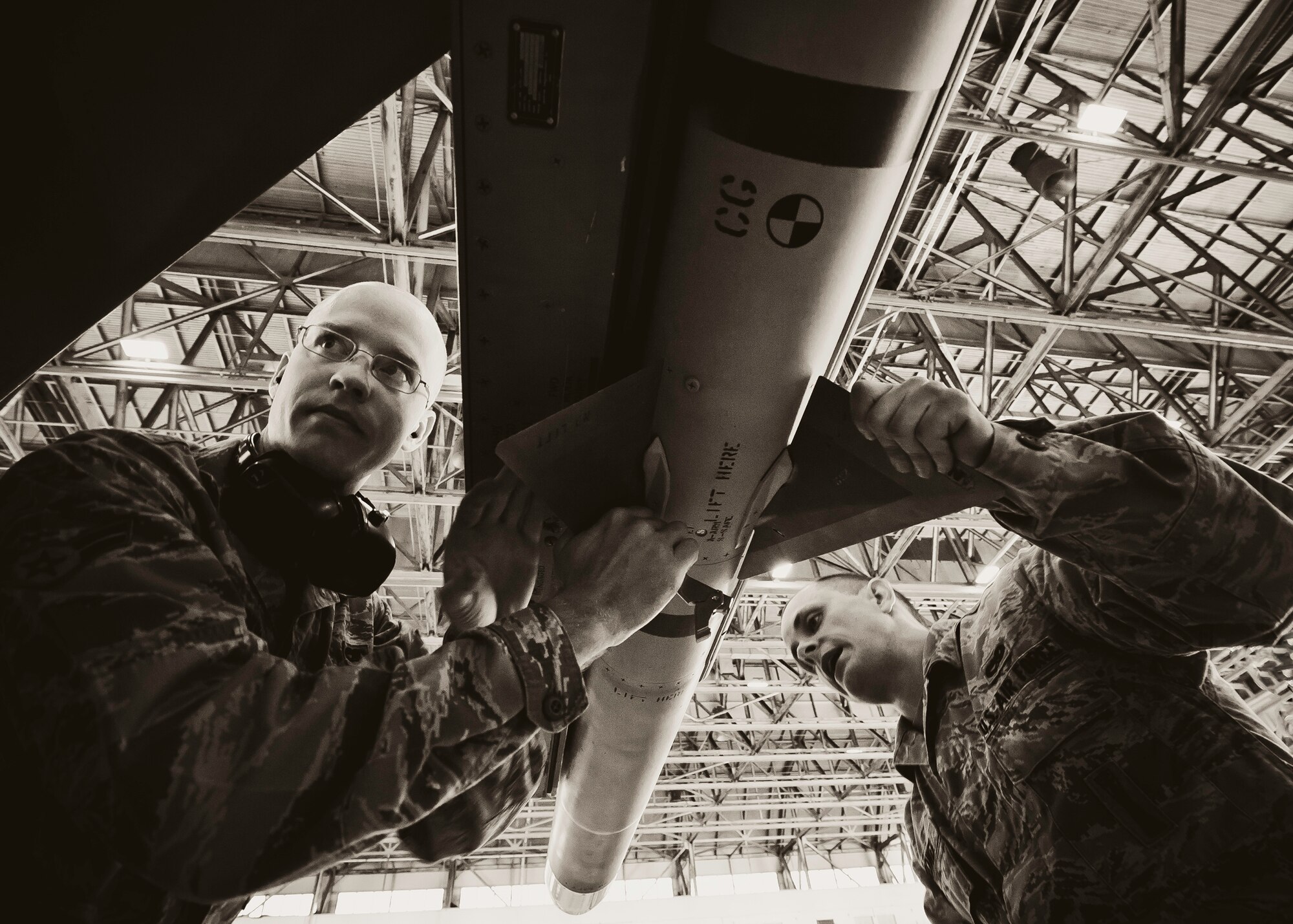 Airman 1st Class Tyler Marking and Senior Airman James Brower, with the 46th Aircraft Maintenance Squadron, make final adjustments to the AIM-9 during the 46th Maintenance Group’s third quarter weapons load competition at Eglin Air Force Base, Fla., Oct. 28.  The best of the best from AMU Red and AMU Blue met to load a Joint Direct Attack Munition and an AIM-9 onto an F-15 and F-16 respectively.  AMU Red won with the best time and fewest errors.  (U.S. Air Force photo/Samuel King Jr.)