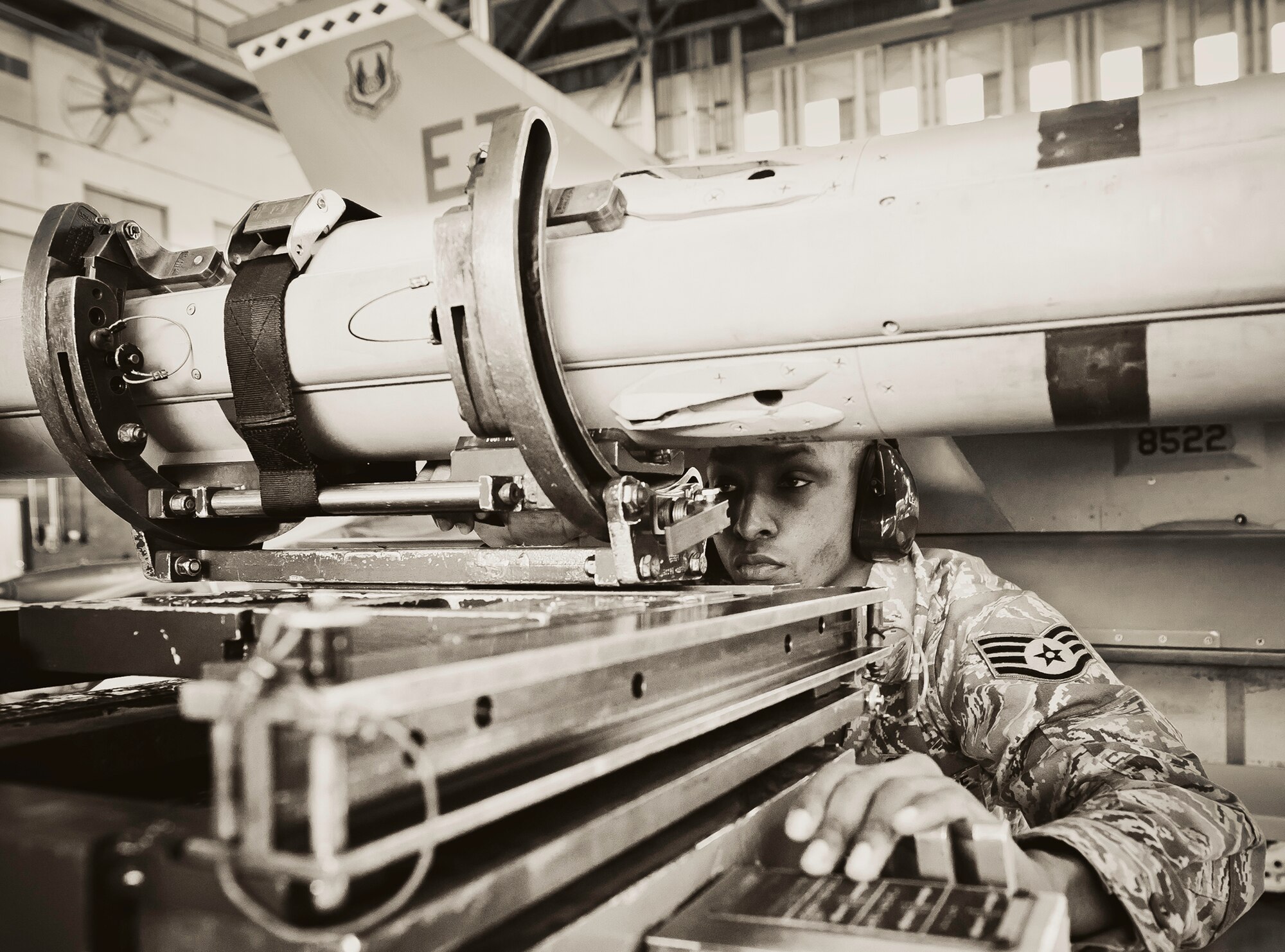 Staff Sgt. Michael Barnes, from the 46th Aircraft Maintenance Squadron, watches as the AIM-9 is moved into place during the 46th Maintenance Group’s third quarter weapons load competition at Eglin Air Force Base, Fla., Oct. 28.  The best of the best from AMU Red and AMU Blue met to load a Joint Direct Attack Munition and an AIM-9 onto an F-15 and F-16 respectively.  AMU Red won with the best time and fewest errors.  (U.S. Air Force photo/Samuel King Jr.)