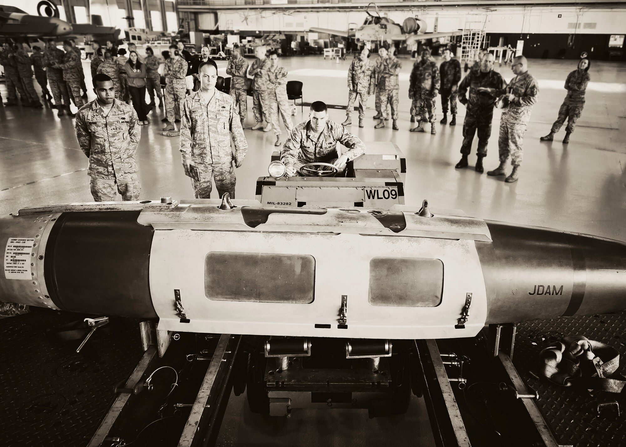 Airman 1st Class Mark Timpani, with the 46th Aircraft Maintenance Squadron, picks up the Joint Direct Attack Munition during the 46th Maintenance Group’s third quarter weapons load competition at Eglin Air Force Base, Fla., Oct. 28.  The best of the best from AMU Red and AMU Blue met to load a Joint Direct Attack Munition and an AIM-9 onto an F-15 and F-16 respectively.  AMU Red won with the best time and fewest errors.  (U.S. Air Force photo/Samuel King Jr.)