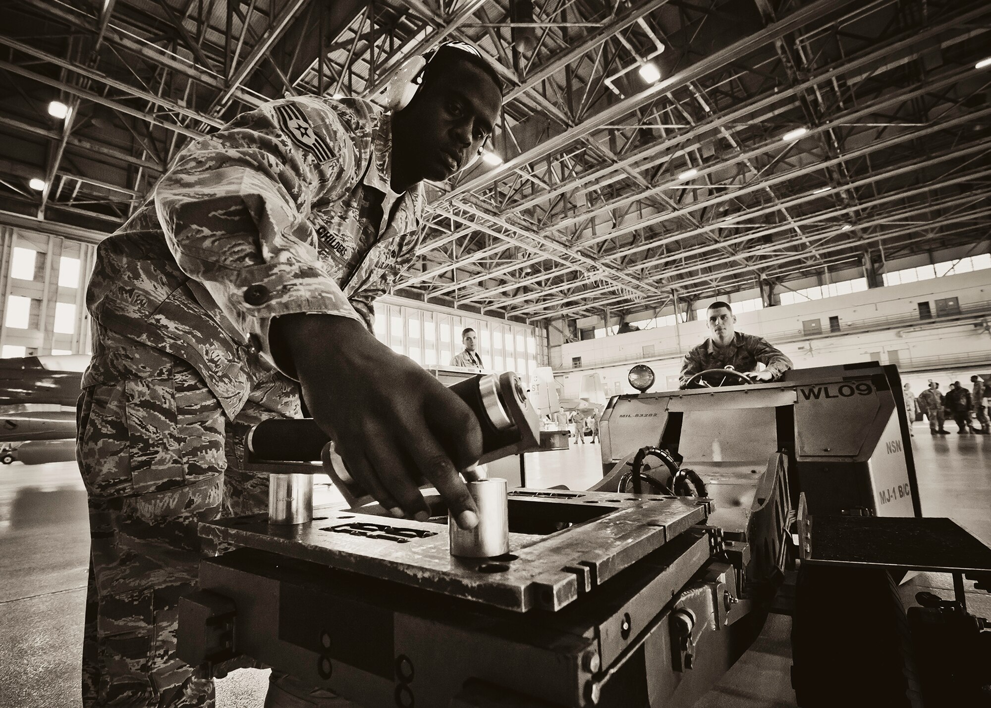 Staff Sgt. Anthony Childers, 46th Aircraft Maintenance Squadron crew leader, places the proper fittings onto the weapon loader during the 46th Maintenance Group’s third quarter weapons load competition at Eglin Air Force Base, Fla., Oct. 28.  The best of the best from AMU Red and AMU Blue met to load a Joint Direct Attack Munition and an AIM-9 onto an F-15 and F-16 respectively.  AMU Red won with the best time and fewest errors.  (U.S. Air Force photo/Samuel King Jr.)