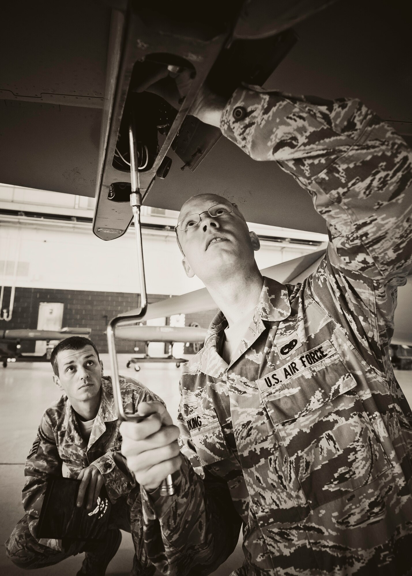 Airman 1st Class Tyler Marking, with the 46th Aircraft Maintenance Squadron, prepares the aircraft before his team loads the weapon during the 46th Maintenance Group’s third quarter weapons load competition at Eglin Air Force Base, Fla., Oct. 28.  The best of the best from AMU Red and AMU Blue met to load a Joint Direct Attack Munition and an AIM-9 onto an F-15 and F-16 respectively.  AMU Red won with the best time and fewest errors.  (U.S. Air Force photo/Samuel King Jr.)