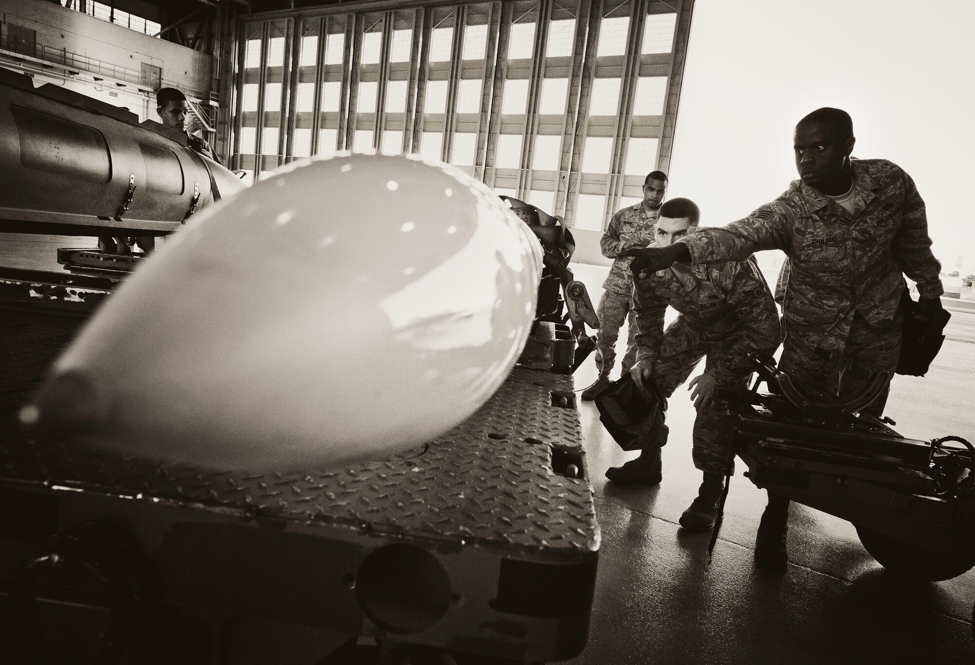 Staff Sgt. Anthony Childers, 46th Aircraft Maintenance Squadron crew leader, points out the next step during the 46th Maintenance Group’s third quarter weapons load competition at Eglin Air Force Base, Fla., Oct. 28.  The best of the best from AMU Red and AMU Blue met to load a Joint Direct Attack Munition and an AIM-9 onto an F-15 and F-16 respectively.  AMU Red won with the best time and fewest errors.  (U.S. Air Force photo/Samuel King Jr.)