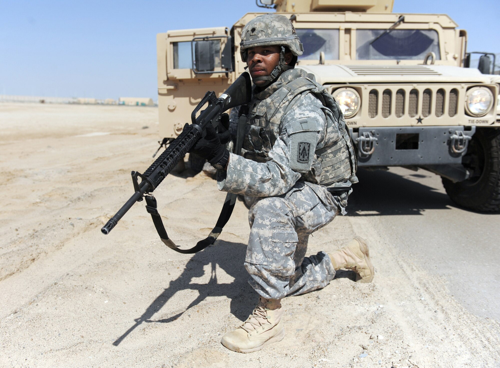 Spc. Johnathan Robinson, a signal systems support specialist for the 3rd Battalion, 4th Air Defense Artillery Regiment, secures the perimeter of a vehicle during convoy training, Oct. 28, 2011, at an air base in Southwest Asia. Airmen from the 380th Expeditionary Security Forces Squadron conducted a tactical convoy training battle drill with the Soldiers of the 3-4 ADAR, Charlie Battery, which covered threat response for things like improvised explosive devices and ambushers as well as wounded-Soldier evacuations and procedures for sending reports up to appropriate channels. (U.S. Air Force photo/Master Sgt. Chance Babin)