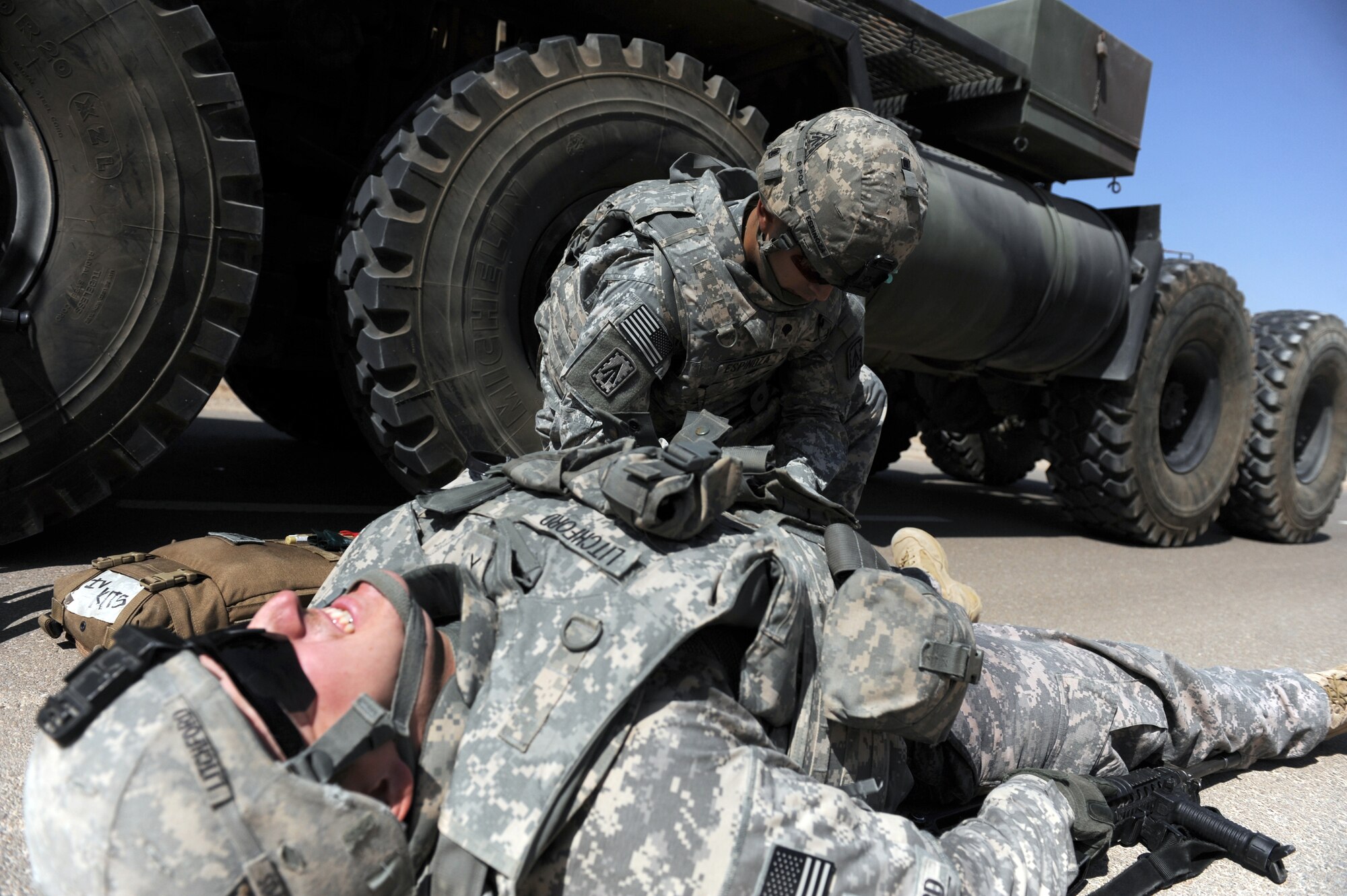 Spc. Josiah Espinoza, a medic with the 3rd Battalion, 4th Air Defense Artillery Regiment, performs combat life- saving procedures on a downed Soldier during convoy training Oct. 28, 2011, at the 380th Air Expeditionary Wing. The Army unit requested this training from the 380th Expeditionary Security Forces Squadron so their Soldiers could learn from Airmen with first-hand experience. The training covered threat response for things like improvised explosive devices and ambushers as well as wounded-Soldier evacuations and procedures for sending reports up to appropriate channels. (U.S. Air Force photo/Master Sgt. Chance Babin)