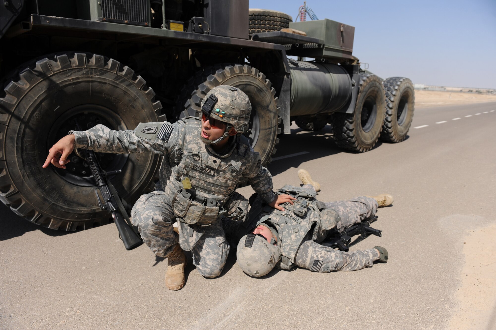 Spc. Josiah Espinoza, a medic with the 3rd Battalion, 4th Air Defense Artillery Regiment, performs combat life- saving procedures on a downed Soldier during convoy training Oct. 28, 2011, at the 380th Air Expeditionary Wing. The Army unit requested this training from the 380th Expeditionary Security Forces Squadron so their Soldiers could learn from Airmen with first-hand experience. The training covered threat response for things like improvised explosive devices and ambushers as well as wounded-Soldier evacuations and procedures for sending reports up to appropriate channels. (U.S. Air Force photo/Master Sgt. Chance Babin)
