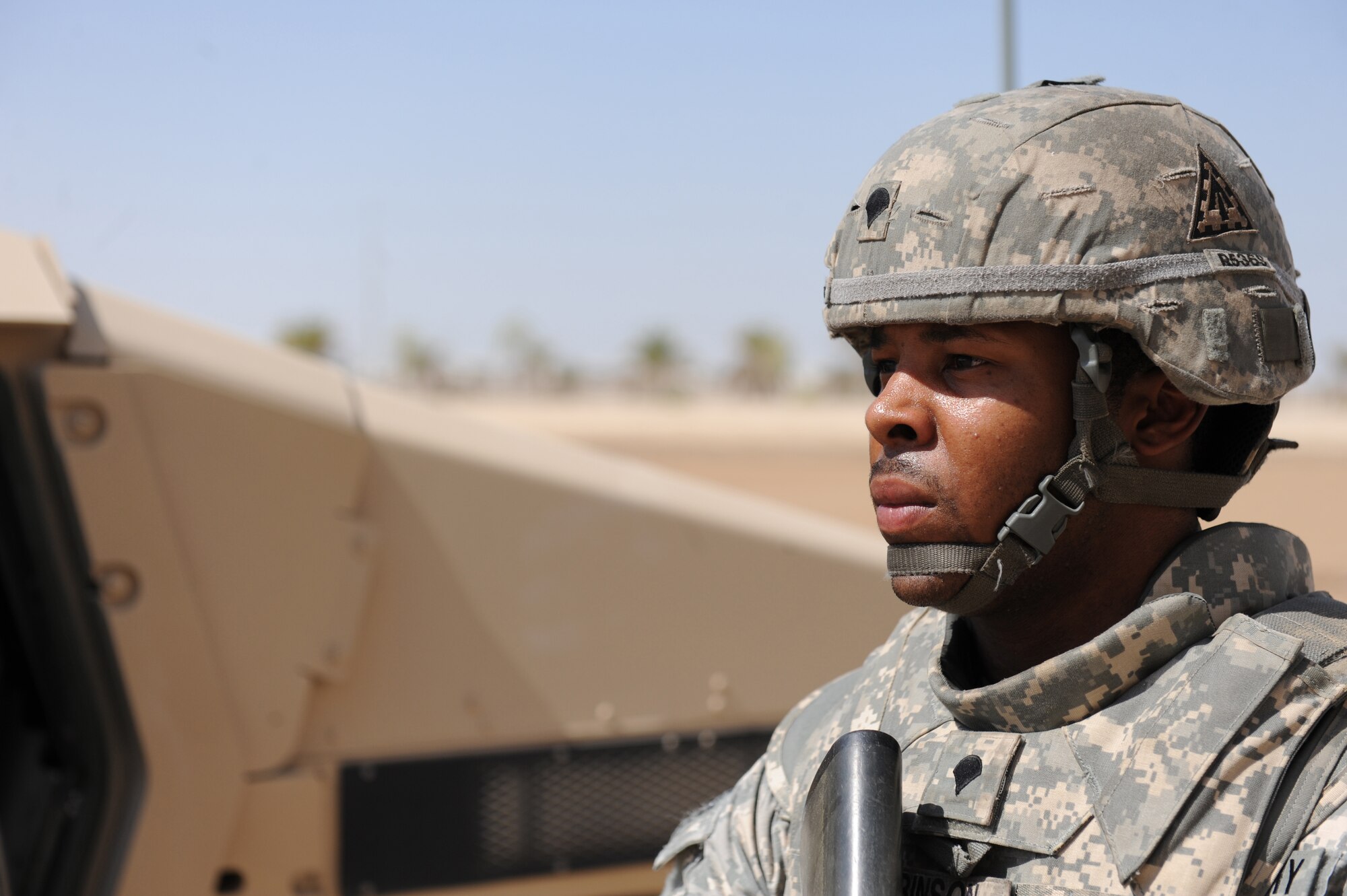 Spc. Johnathan Robinson, a signal systems support specialist for the 3rd Battalion, 4th Air Defense Artillery Regiment, secures the perimeter of a vehicle during convoy training, Oct. 28, 2011, at an air base in Southwest Asia. Airmen from the 380th Expeditionary Security Forces Squadron conducted a tactical convoy training battle drill with the Soldiers of the 3-4 ADAR, Charlie Battery, which covered threat response for things like improvised explosive devices and ambushers as well as wounded-Soldier evacuations and procedures for sending reports up to appropriate channels. (U.S. Air Force photo/Master Sgt. Chance Babin)