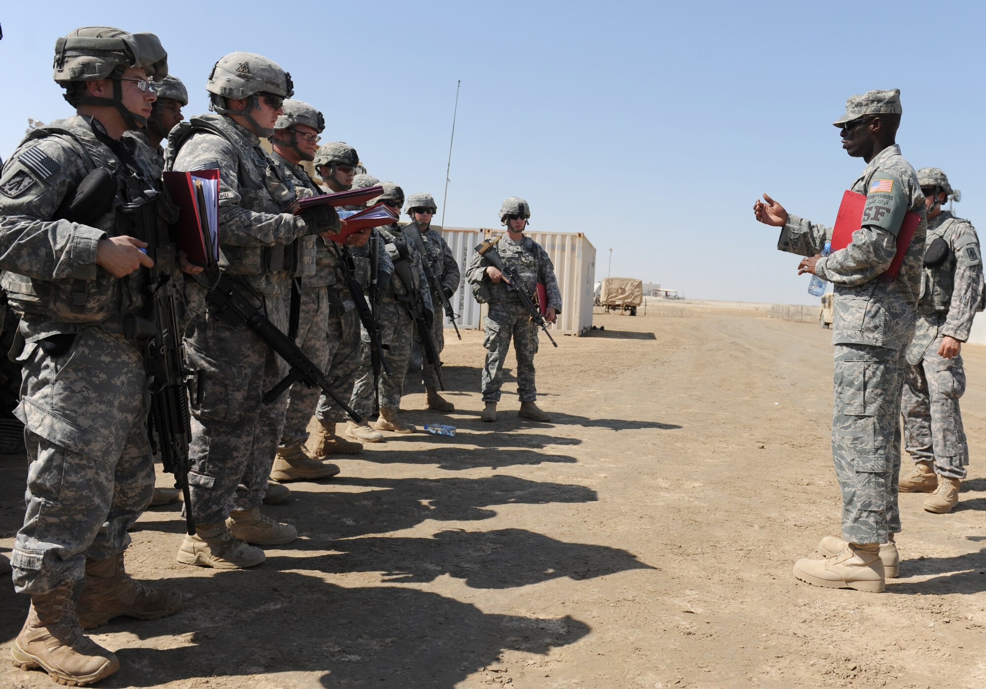 Tech. Sgt. Anthony Harris, the NCO in charge of training for the 380th Expeditionary Security Forces Squadron, briefs members of the Army's 3rd Battalion, 4th Air Defense Artillery Regiment prior to conducting convoy training Oct. 28, 2011, at the 380th Air Expeditionary Wing. The training covered threat response for things like improvised explosive devices and ambushers as well as wounded-Soldier evacuations and procedures for sending reports up to appropriate channels. Harris is from Cincinnati, Ohio. (U.S. Air Force photo/Master Sgt. Chance Babin)