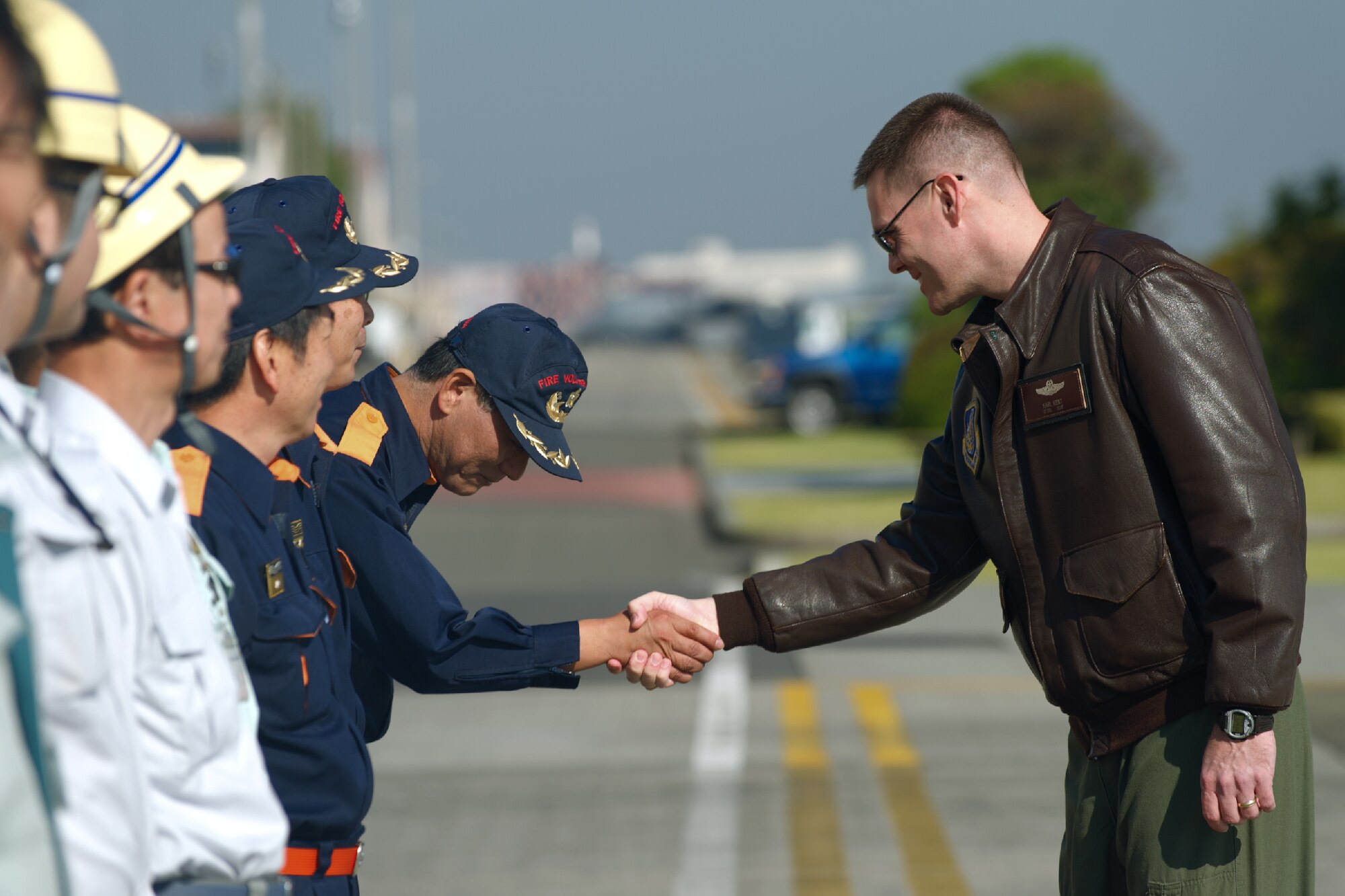 YOKOTA AIR BASE, Japan -- Lt. Col. Karl Kent, 374th Airlift Wing plans and exercises chief, shakes hands with Tokyo Metropolitan Government Comprehensive Disaster Prevention Drill participants at Yokota Air Base, Japan, Oct. 29, 2011. Yokota personnel practiced emergency responses with local Hospitals and Japan Ground Self-Defense Force. (U.S. Air Force photo/Osakabe Yasuo) 