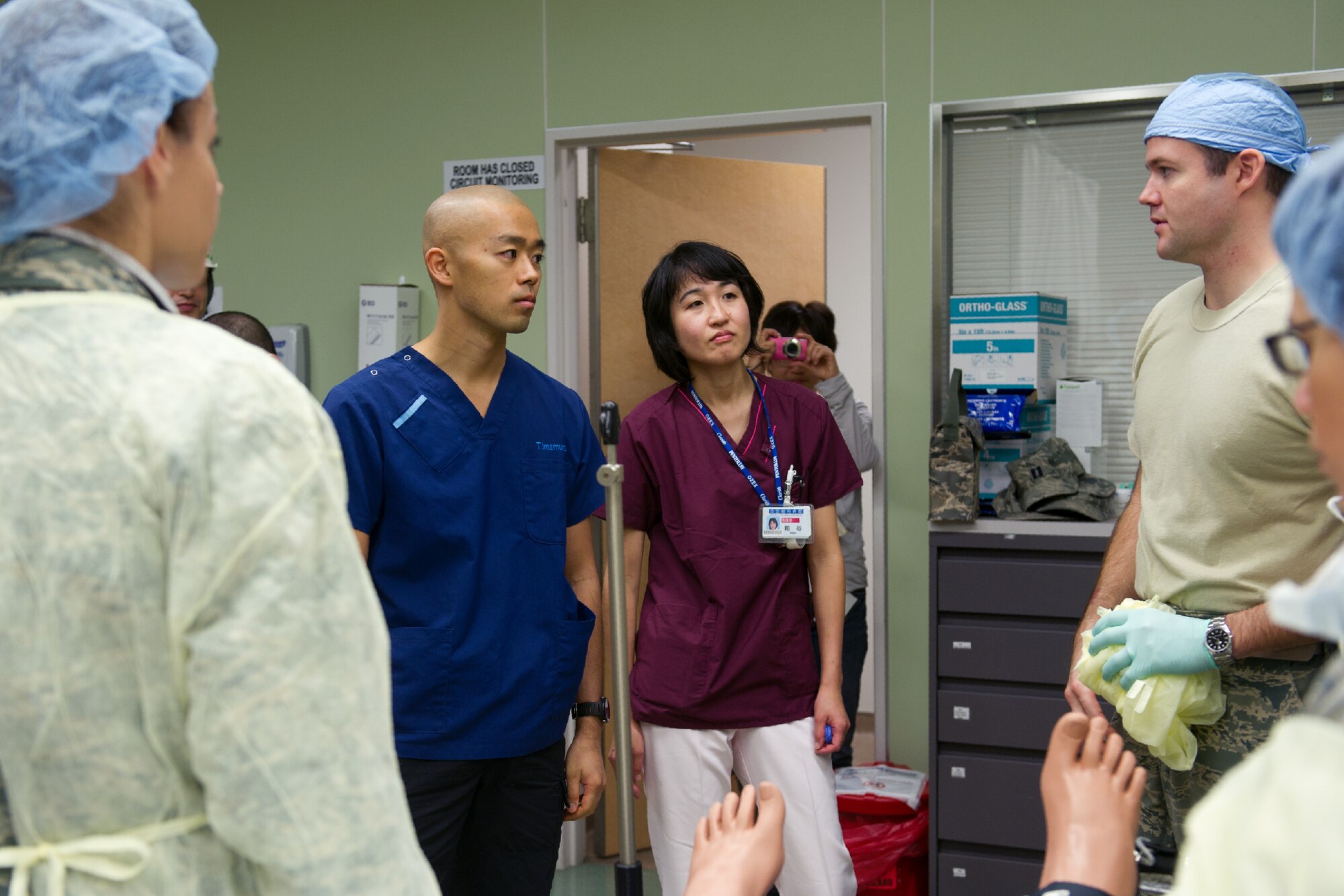 YOKOTA AIR BASE, Japan -- Members from the 374th Surgical Operations Squadron explain surgery procedures to Dr. Takeaki Imamura (left) and Ms. Erika Kasuya (right), both from Showa General Hospital, at Yokota's base hospital, Oct. 29, 2011 during a Tokyo Metropolitan Government Comprehensive Disaster Prevention Drill. Yokota personnel practiced emergency responses with local Hospitals and Japan Ground Self-Defense Force. (U.S. Air Force photo/Osakabe Yasuo) 