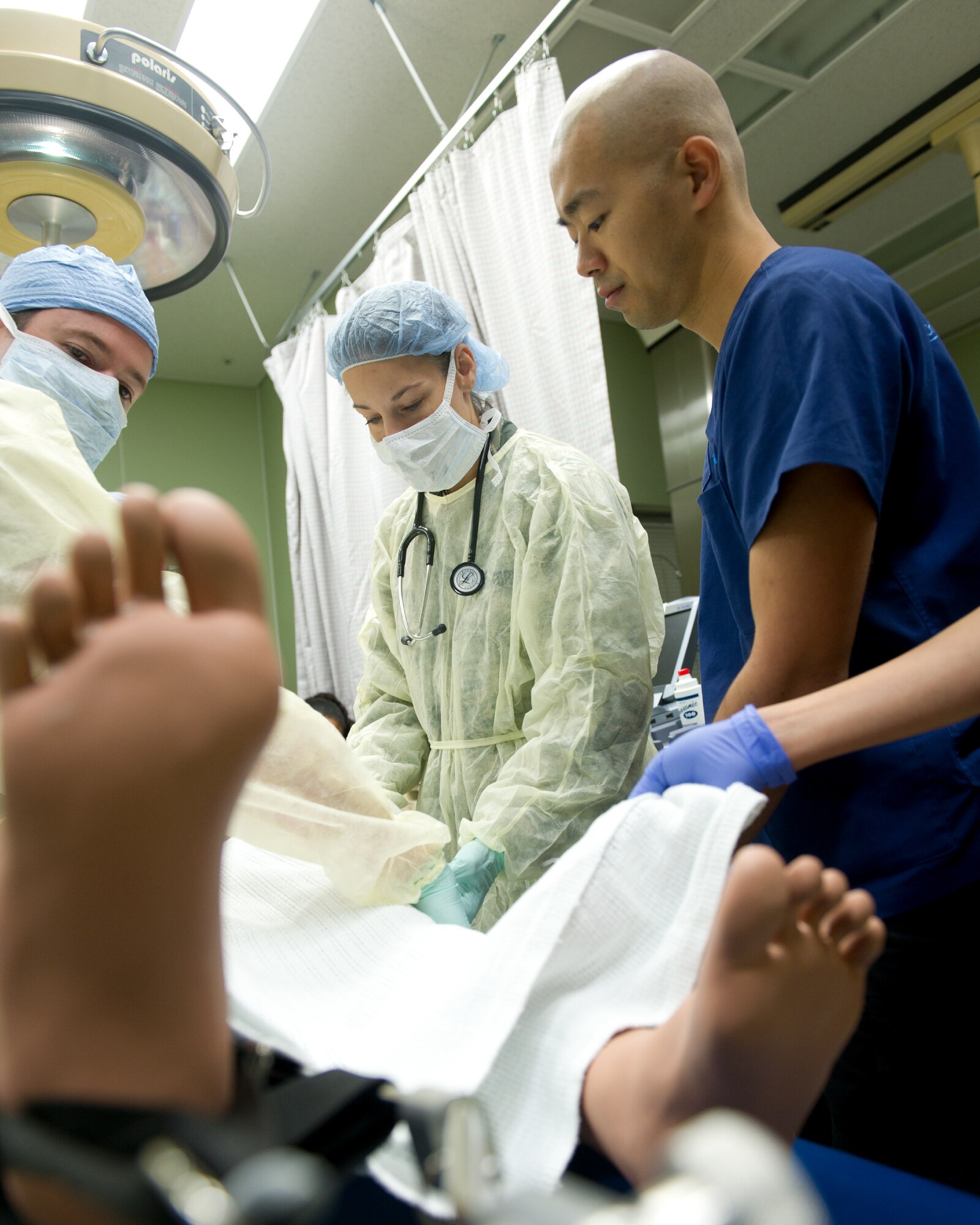 YOKOTA AIR BASE, Japan -- Members from the 374th Surgical Operations Squadron and a doctor from the Showa General Hospital work together to treat a simulated patient at Yokota's base hospital, Oct. 29, 2011 during a Tokyo Metropolitan Government Comprehensive Disaster Prevention Drill. Yokota personnel practiced emergency responses with local Hospitals and Japan Ground Self-Defense Force. (U.S. Air Force photo/Osakabe Yasuo)