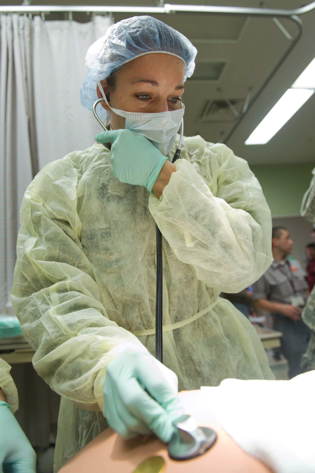YOKOTA AIR BASE, Japan -- Capt. Karina Glover, 374th Surgical Operations Squadron General surgical assistant, listens to the breathing of a simulated patient at Yokota's base hospital, Oct. 29, 2011 during a Tokyo Metropolitan Government Comprehensive Disaster Prevention Drill. Yokota personnel practiced emergency responses with local Hospitals and Japan Ground Self-Defense Force. (U.S. Air Force photo/Osakabe Yasuo) 
