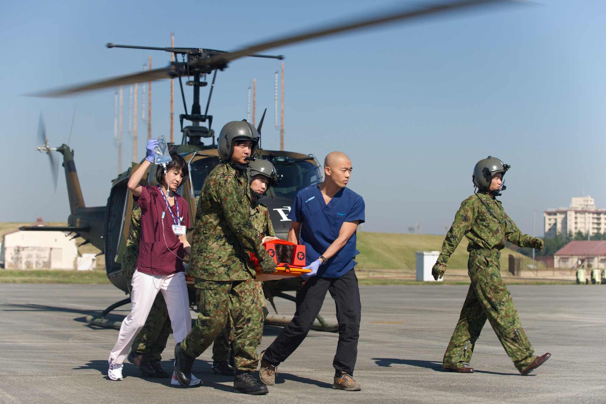 YOKOTA AIR BASE, Japan -- Members from Japan Ground Self-Defense Force and medical personnel from the Showa General Hospital unload a simulated patient from a JGSDF UH-1 helicopter at Yokota Air Base, Japan, Oct. 29, 2011 during a Tokyo Metropolitan Government Comprehensive Disaster Prevention Drill. Yokota personnel practiced emergency responses with local Hospitals and Japan Ground Self-Defense Force.(U.S. Air Force photo/Osakabe Yasuo)