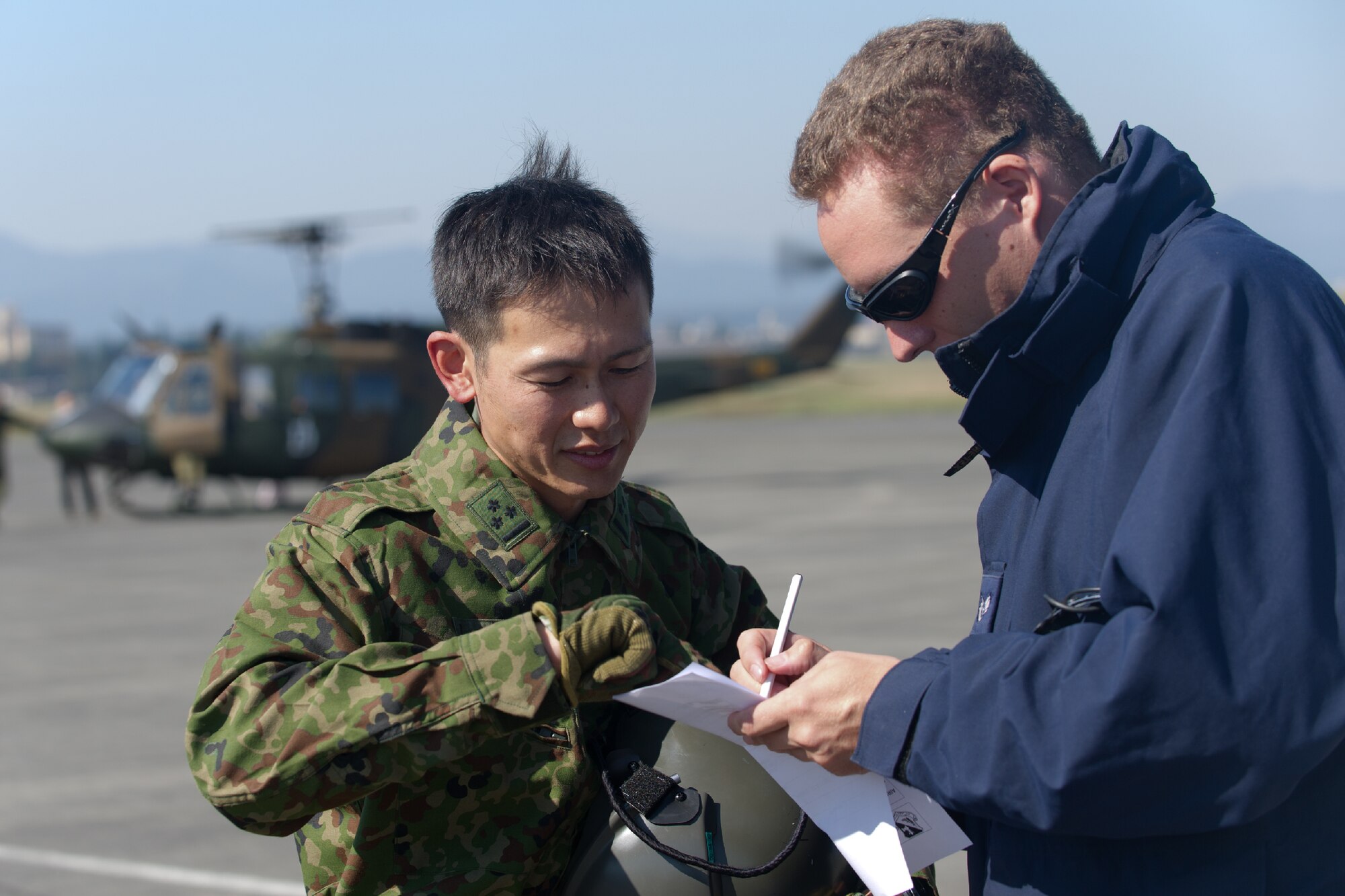 YOKOTA AIR BASE, Japan -- Staff Sgt. Jason Estes, 374th Maintenance Squadron transient alert technician, and Capt. Imamura Takaharu, Japan Ground Self-Defense Force, discuss their flight plan at Yokota Air Base, Japan, Oct. 29, 2011 during a Tokyo Metropolitan Government Comprehensive Disaster Prevention Drill. Yokota personnel practiced emergency responses with local hospitals and the Japan Ground Self-Defense Force. (U.S. Air Force photo/Osakabe Yasuo) 