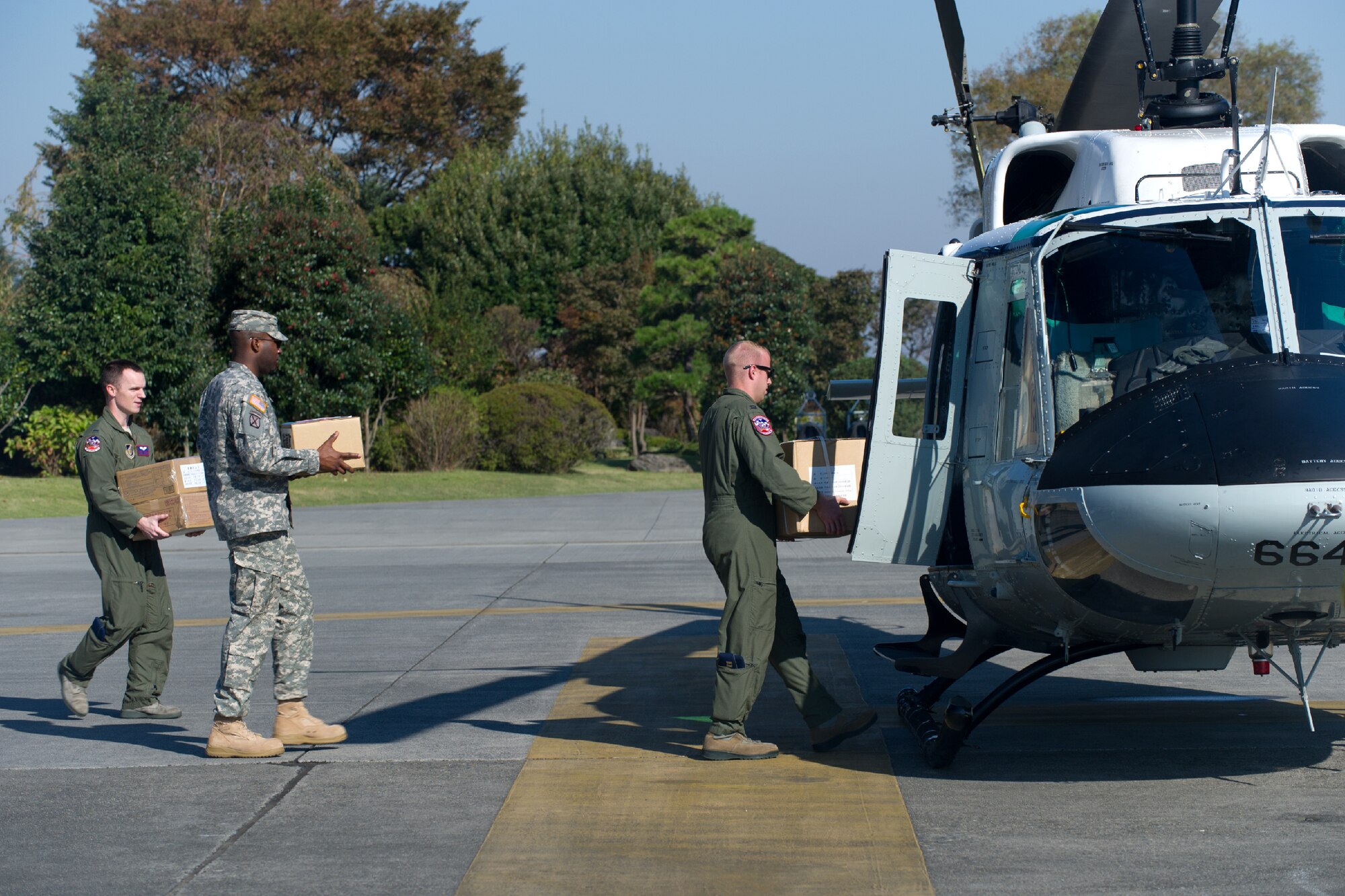 YOKOTA AIR BASE, Japan -- Airmen from the 459th Airlift Squadron load simulated relief supplies at Yokota Air Base, Japan, Oct. 29, 2011 during a Tokyo Metropolitan Government Comprehensive Disaster Prevention Drill. Yokota personnel practiced delivering simulated relief supplies to Koganei Park in downtown Tokyo. (U.S. Air Force photo/Osakabe Yasuo)