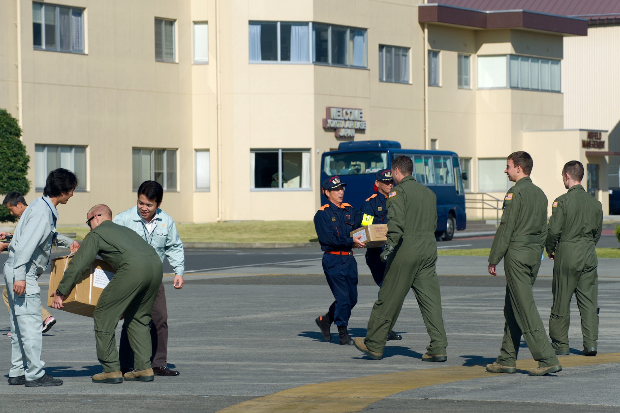 YOKOTA AIR BASE, Japan -- Airmen from the 459th Airlift Squadron load simulated relief supplies at Yokota Air Base, Japan, Oct. 29, 2011 during a Tokyo Metropolitan Government Comprehensive Disaster Prevention Drill. Yokota personnel practiced delivering simulated relief supplies to Koganei Park downtown Tokyo. (U.S. Air Force photo/Osakabe Yasuo)