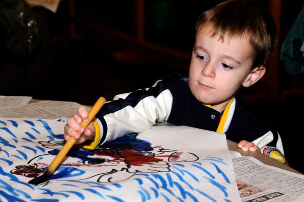 Luke Anderson, son of Tech. Sgt. Calen Anderson, 373rd Support Squadron, paints a picture for his "gonohe" kite during the 24th annual Japan Day, at Misawa Air Base, Japan, Oct. 29. Japan Day is an opportunity for Misawa residents and their families to immerse themselves in various aspects of the Japanese culture. (U.S. Air Force photo/Tech. Sgt. Marie Brown) 
