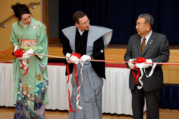 Jenn Rothstein, left, along with her husband Col. Michael D. Rothstein, 35th Fighter Wing commander, center, and the Honorable Kazumasa Taneichi, Misawa City mayor, cut the ribbon to kick off the 24th annual Japan Day, at Misawa Air Base, Japan, Oct. 29. Japan Day is an opportunity for Misawa residents and their families to immerse themselves in various aspects of the Japanese culture. (U.S. Air Force photo/Tech. Sgt. Marie Brown) 

