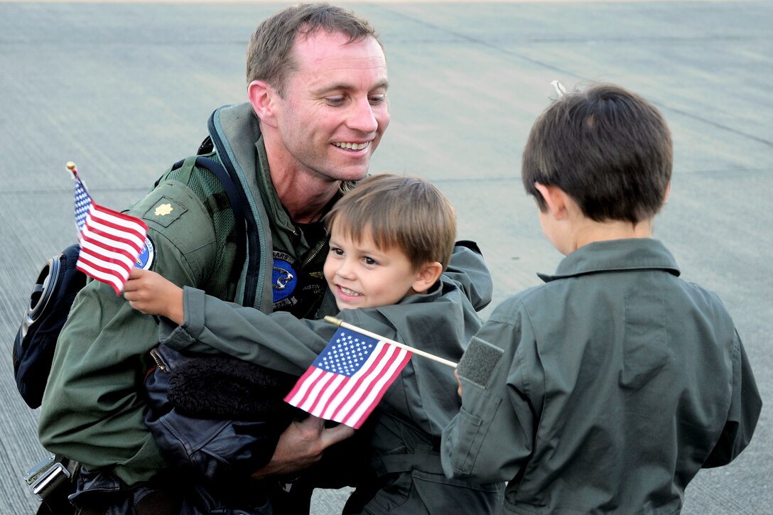 Lt. Cmdr. Justin Griffin is greeted by family members during a homecoming ceremony following a seven month deployment aboard the USS Ronald Reagan at Naval Air Station Whidbey Island, Wash., Sept. 6, 2011. Griffin is assigned to Electronic Attack Squadron 139. 
