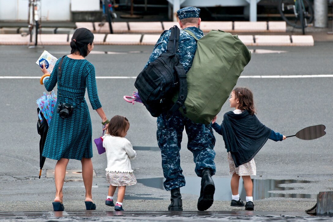 U.S. Navy Petty Officer 1st Class Christopher Binnings leaves with his family after returning from summer patrol to Commander Fleet Activities, Yokosuka, Japan, Aug. 22, 2011. Binnings is an information systems technician assigned to the guided-missile destroyer USS McCampbell.
