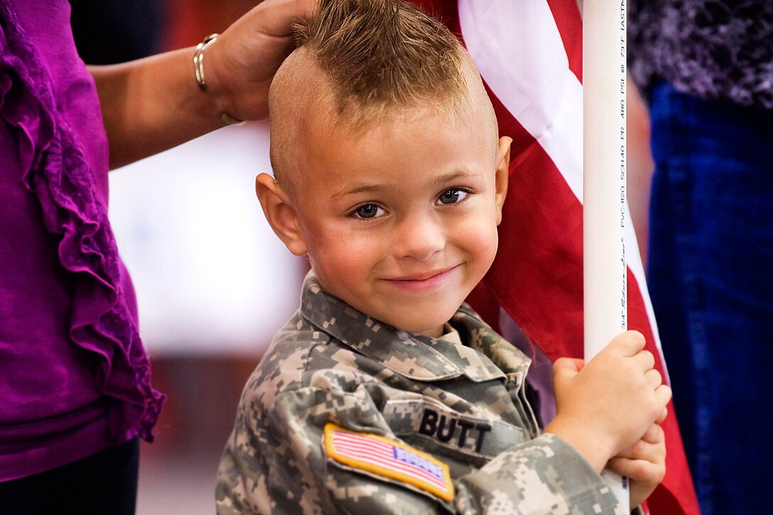 Gunner Butt, son of Army Sgt. 1st Class Walter Butt, stands with his family and others waiting for the return of their deployed soldiers from Afghanistan at Stout Field, Indianapolis, Aug. 10, 2011. Walter Butt was assigned to the 3-19th Agribusiness Development Team.
