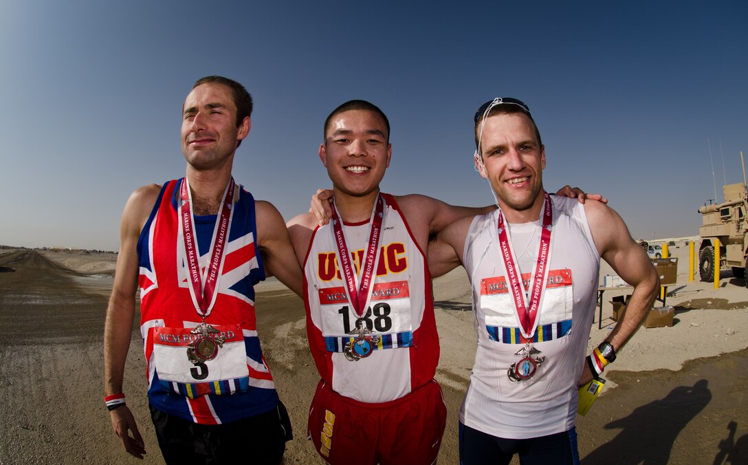 British Army Capt. Frazer Alexander, left, U.S. Marine Corps 1st Lt. Andrew Lee, center, and Estonian Army Capt. Andre Silver pose for a photo after completing the Marine Corps Marathon Forward on Camp Leatherneck in Afghanistan, Oct. 30, 2011. Alexander placed first, Lee second and Silver third. 