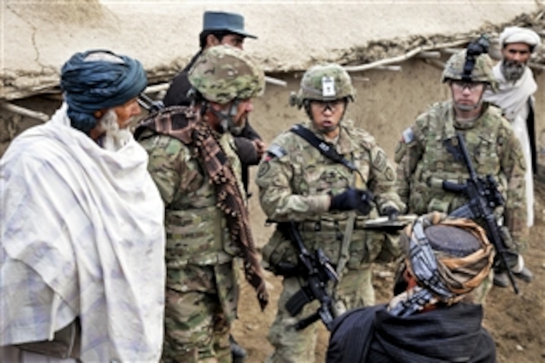 U.S. Army Spc. Lee, center, and Army Capt. Jeremy Teter, right, address the concerns of the village elder during Operation Moose Kill II in Qalat, Afghanistan, Oct. 22, 2011. Lee and Teter are assigned to Company C, 1st Battalion, 24th Infantry Regiment. Afghan police and Company C soldiers searched the villages of Musa Khely and Nowrak to disrupt improvised bomb attacks.