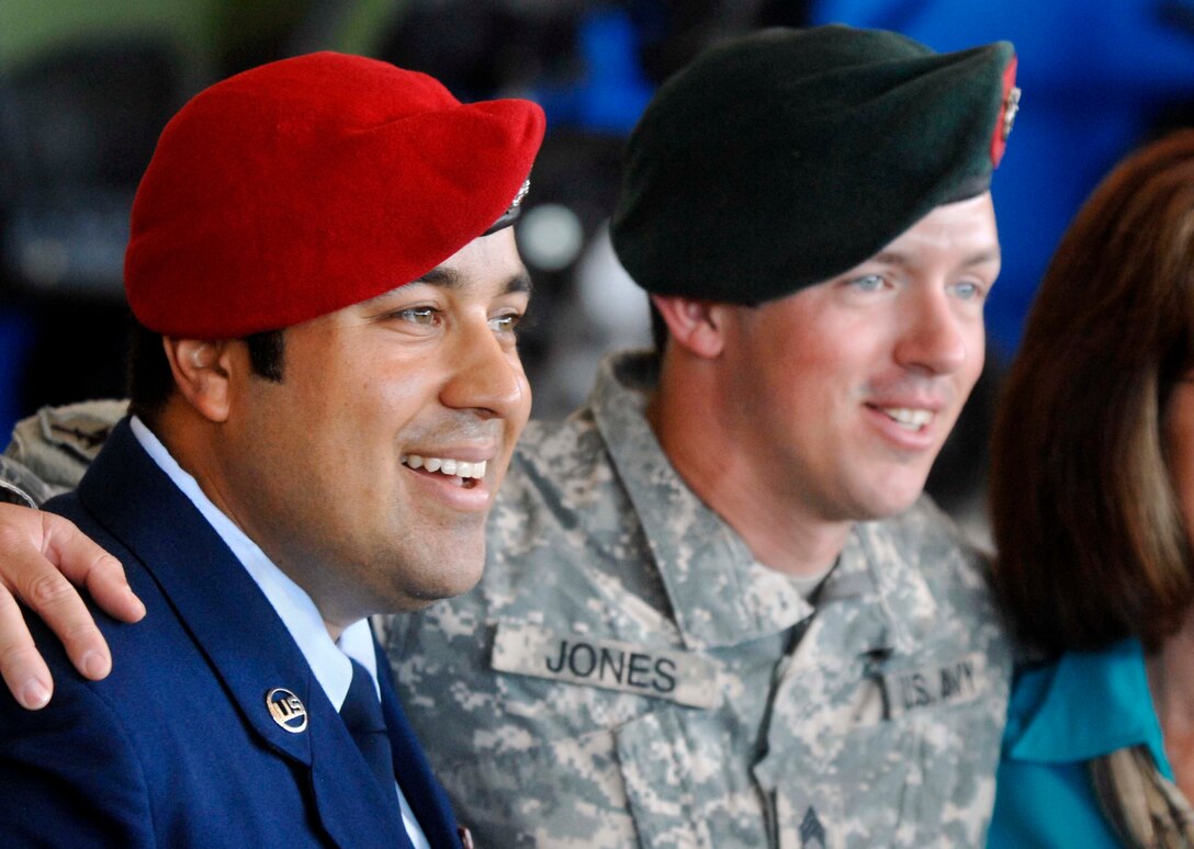 An airman and a soldier smile for a photo.