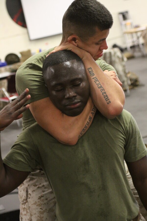 Cpl. Jared Kerness, meteorology and oceanography forecaster, Headquarters and Headquarters Squadron, Marine Corps Air Station Miramar, practices his rear chokes on Cpl. Kofi Agyeman, finance clerk, Service Company, Headquarters and Service Battalion during the Martial Arts Instructor Course at the Martial Arts Training Facility aboard Marine Corps Recruit Depot San Diego Oct. 31. The three-week course will enable them to train Marines in Marine Corps Martial Arts up to their belt level.