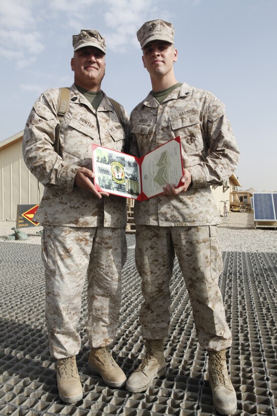 Master Gunnery Sgt. James Hunter, the Marine Aviation Logistics Squadron 40 maintenance chief, stands with his newly promoted son, Cpl. Nathan Hunter, a 2nd Marine Aircraft Wing (Forward) embarkation clerk at Camp Leatherneck, Afghanistan, Sept. 1.  While Nathan has been deployed for about seven months, his father only arrived about a month ago. Both Marines said since they try to enjoy each other’s company as much as possible by sharing meals and staying in contact.