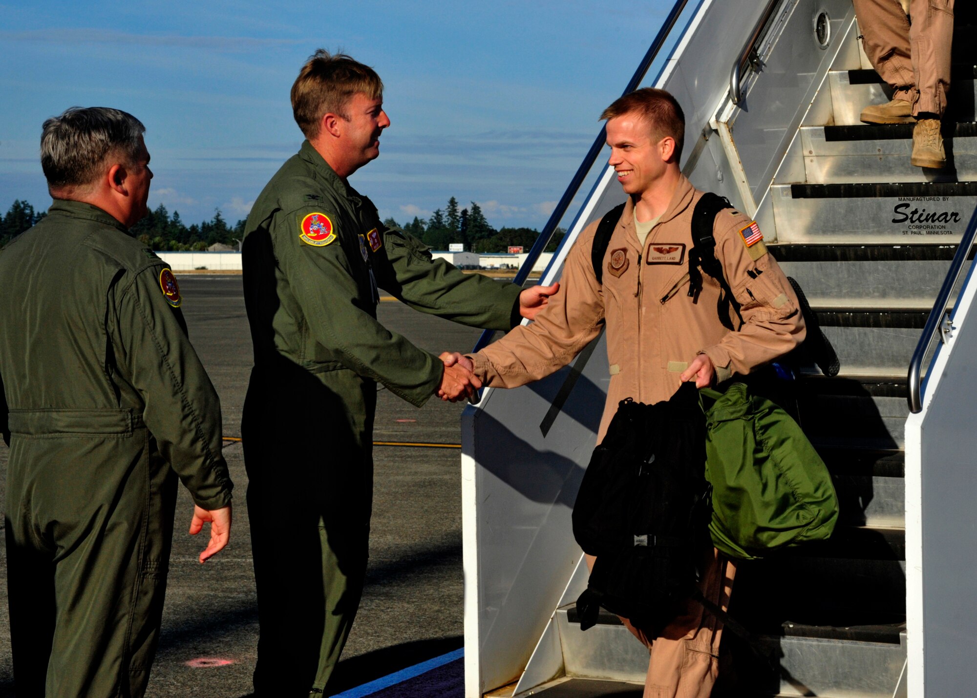 Col. R. Wyn Elder, 62nd Airlift Wing commander, greets 1st Lt. Garrett Land, 10th Airlift Squadron, Sept. 1, 2011, during a redeployment at Joint Base Lewis-McChord, Wash. The 10th AS completed a 120-day deployment in support of Operations Enduring Freedom and New Dawn. (U.S. Air Force Photo/Staff Sgt. Frances Kriss)