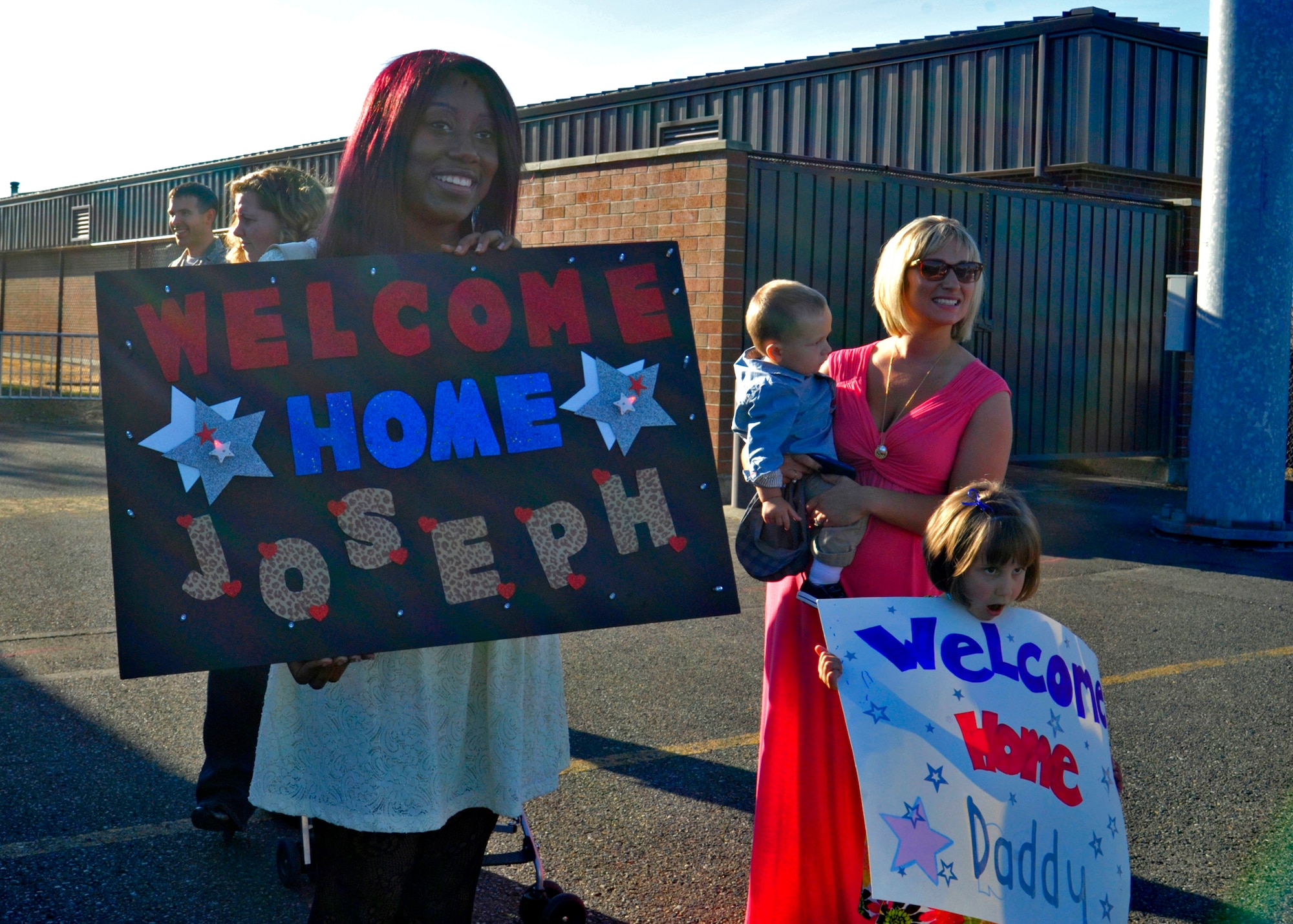 Crissy Timpson, wife of Airman 1st Class Joseph Timpson, 10th Airlift Squadron, and family members of Staff Sgt. Sean Sullivan, 10th AS, wait Sept. 1, 2011, at Joint Base Lewis-McChord, Wash., for the return of their loved ones from a deployment.  (U.S. Air Force Photo/Staff Sgt. Frances Kriss)