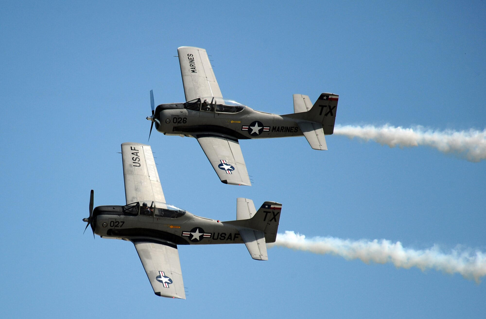 Two T-28's perform a flyby as they end their performance at the 2011 Defenders of Freedom Air Show and Open House Aug. 27.  An estimated 110 thousand people attended the air show Aug. 27 - 28, to get a firsthand look at the U.S. military and learn about its rich heritage. (U.S. Air Force photo by Josh Plueger)