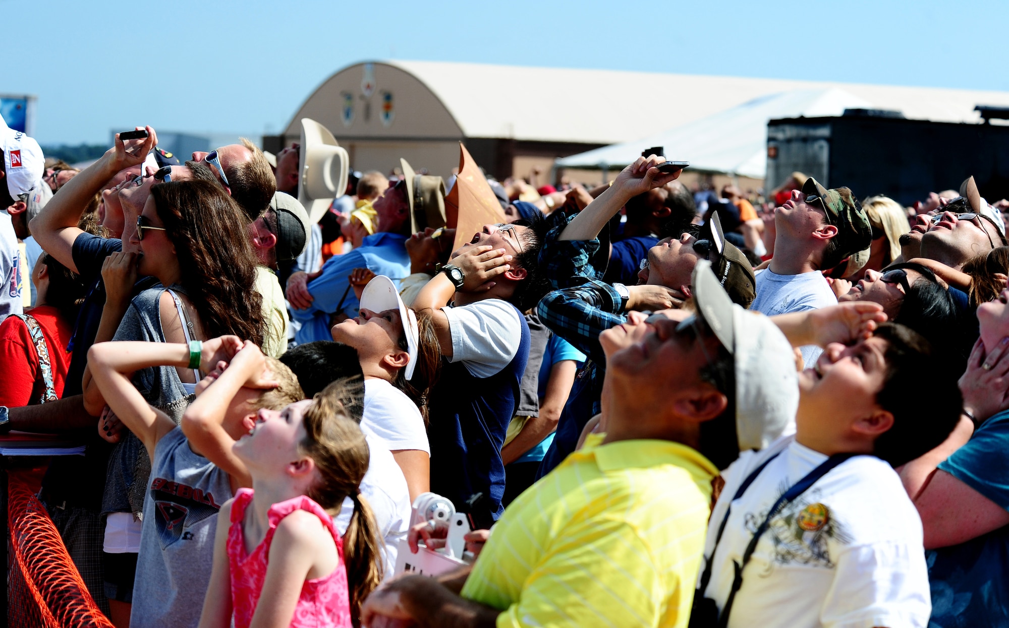People watch as the Air Combat Command F-15E Strike Eagle Demo Team performs at the 2011 Defenders of Freedom Open House and Air Show at Offutt Air Force Base, Neb. Aug. 27 - 28.  The F-15E Strike Eagle Demo Team, based at Seymour-Johnson Air Force Base, N.C., displayed the F-15E's capabilities and maneuverability. (U.S. Air Force photo by Josh Plueger) 