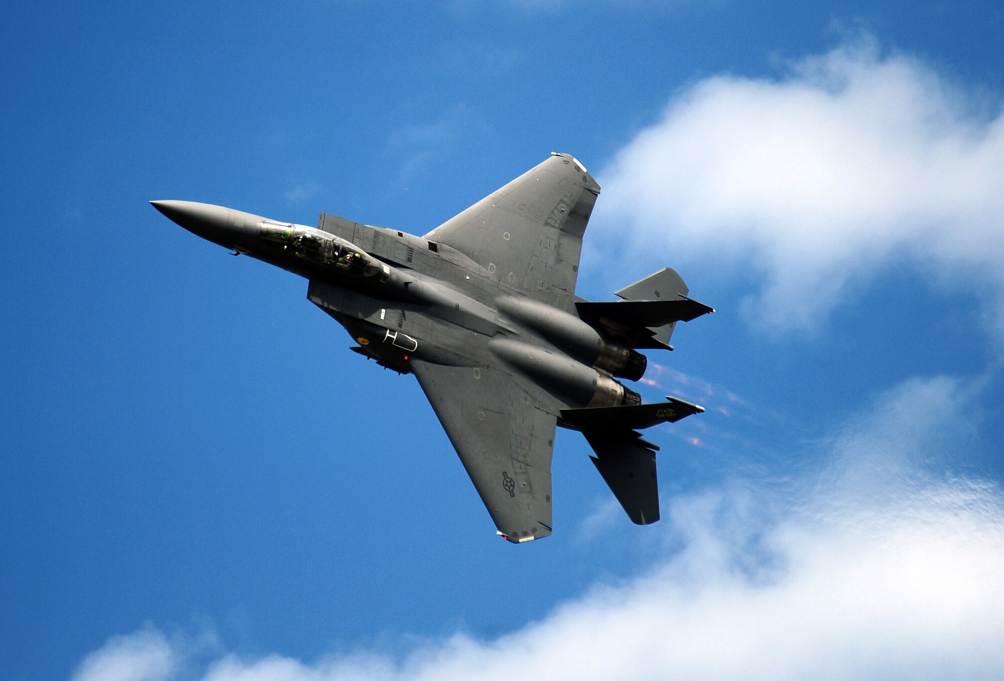 An F-15E Strike Eagle soars over the Offutt Air Force Base runway showcasing the F-15E's capabilities at the 2011 Defenders of Freedom Open House and Air Show Aug. 27.  The F-15E is a dual-role fighter with two crew members, a pilot and a weapons systems officer, performing air- to-air and air-to-ground missions. (U.S. Air Force photo by Josh Plueger)