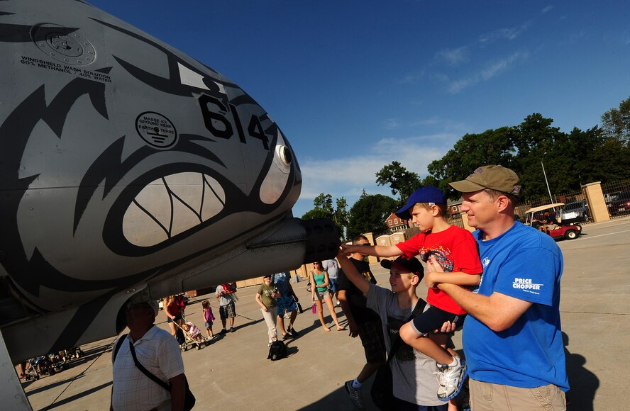 James Geer and his two sons Cole (6) and Ethan (11), look at the A-10 Thunderbolt II GAU-8/A 30 mm cannon while attending the 2011 Defenders of Freedom Open House and Air Show at Offutt Air Force Base, Neb., Aug. 27. The A-10, also referred to as the Warthog, has participated in operations Desert Storm, Southern Watch, Provide Comfort, Desert Fox, Noble Anvil, Deny Flight, Deliberate Guard, Allied Force, Enduring Freedom and Iraqi Freedom. (U.S. Air Force photo by Josh Plueger)