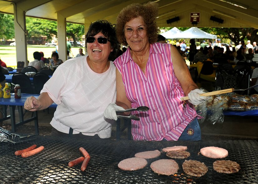 Deborah Waltjen, communication planner (A6X), and Barbie Coleman Administration Assistant (A6X), pose as they enjoy grilling hamburgers and hot dogs during Mahalo Bash 2011, at Joint Base Pearl Harbor-Hickam, Sept. 1.  The Mahalo Bash is an annual event hosted by the Pacific Air Forces commander to thank Airmen and their families for their service and hard work throughout the year. (U.S. Air Force photo/Tech. Sgt. Jerome S. Tayborn (Released))