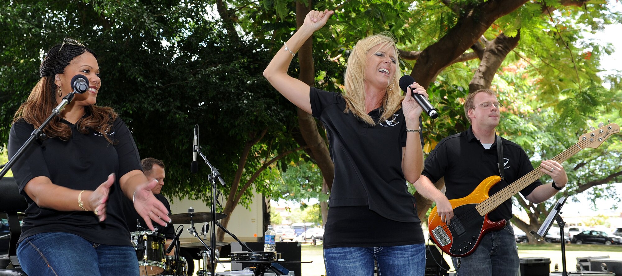 Tech. Sgt. Tamiko Boone, and Master Sgt. (select) Lara Murdzia, members of the U.S. Air Force Band of the Pacific-Hawaii “Hana Hou,” sing during Mahalo Bash 2011, at Joint Base Pearl Harbor-Hickam, Sept. 1.  The Mahalo Bash is an annual event hosted by the Pacific Air Forces commander to thank Airmen and their families for their service and hard work throughout the year. (U.S. Air Force photo/Tech. Sgt. Jerome S. Tayborn/Released)